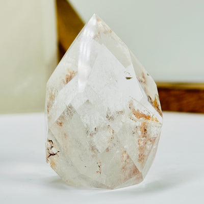 crystal quartz point with decorations in the background