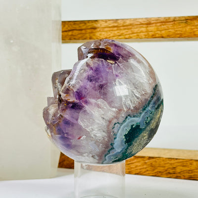 amethyst sphere with decorations in the background