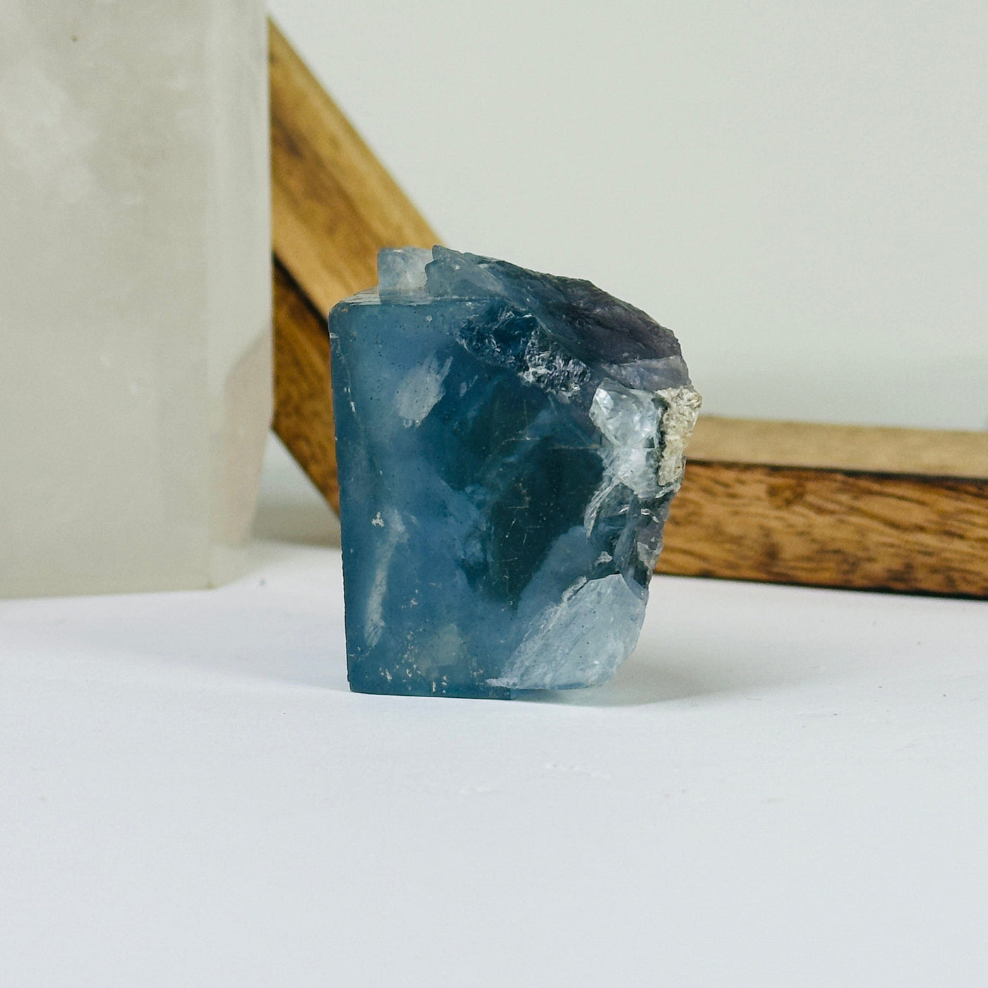 Blue fluorite crystal with decorations in the background