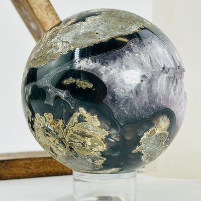 amethyst sphere with decorations in the background