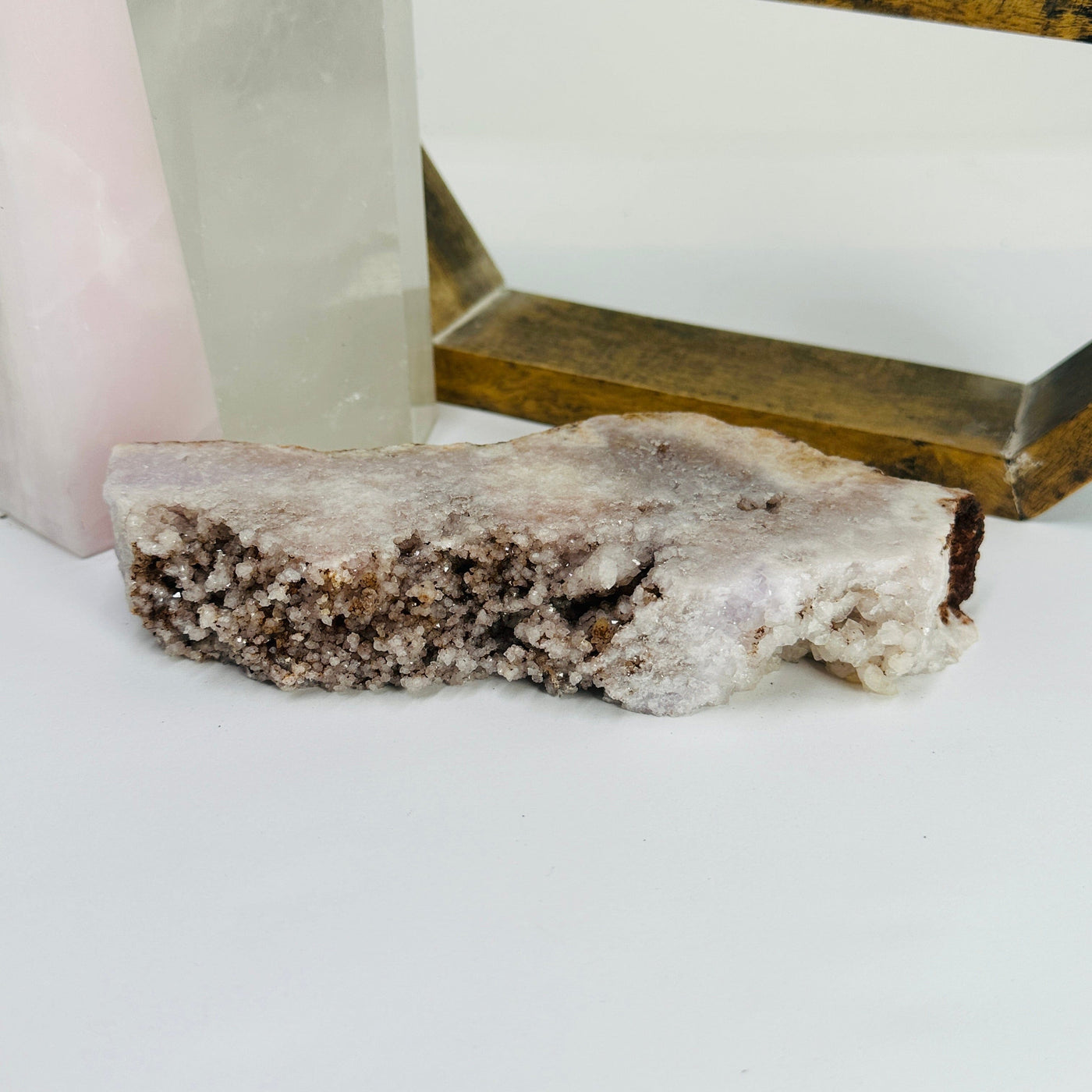 pink amethyst slab with decorations in the background