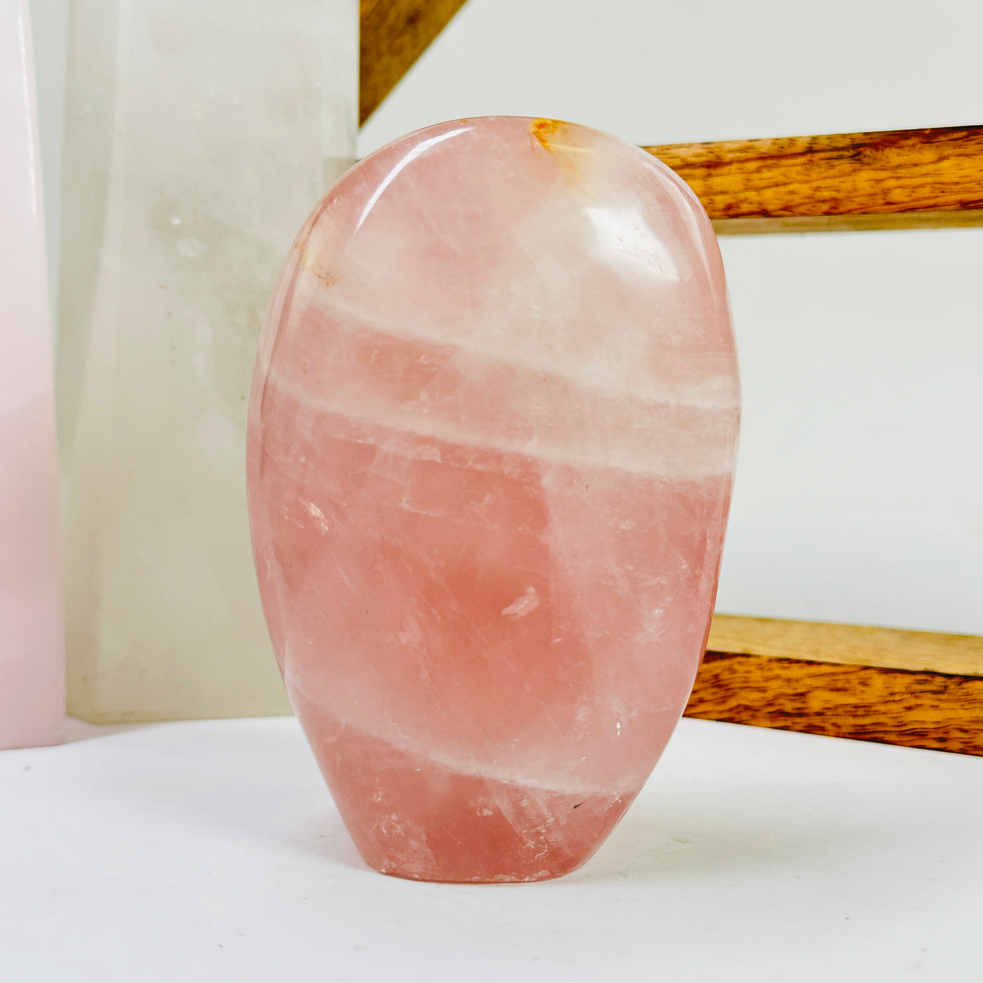 rose quartz cut base with decorations in the background