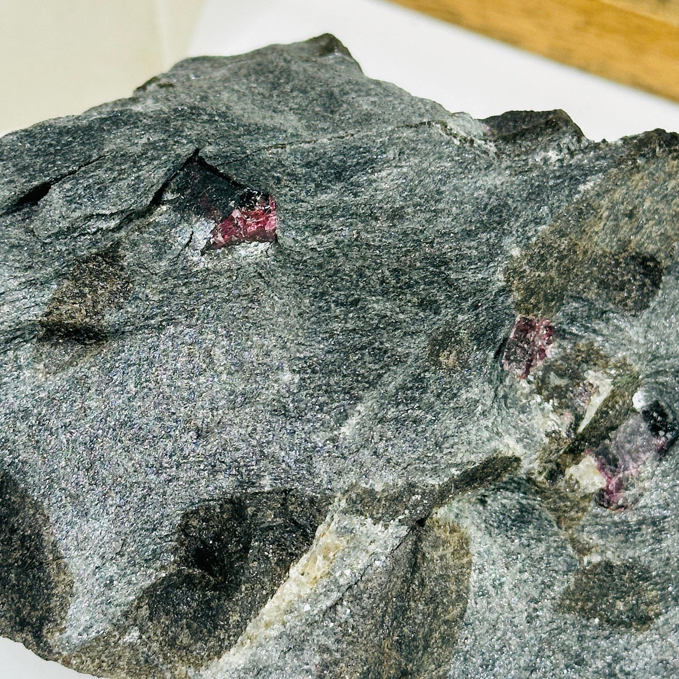 garnet on hematite matrix with decorations in the background