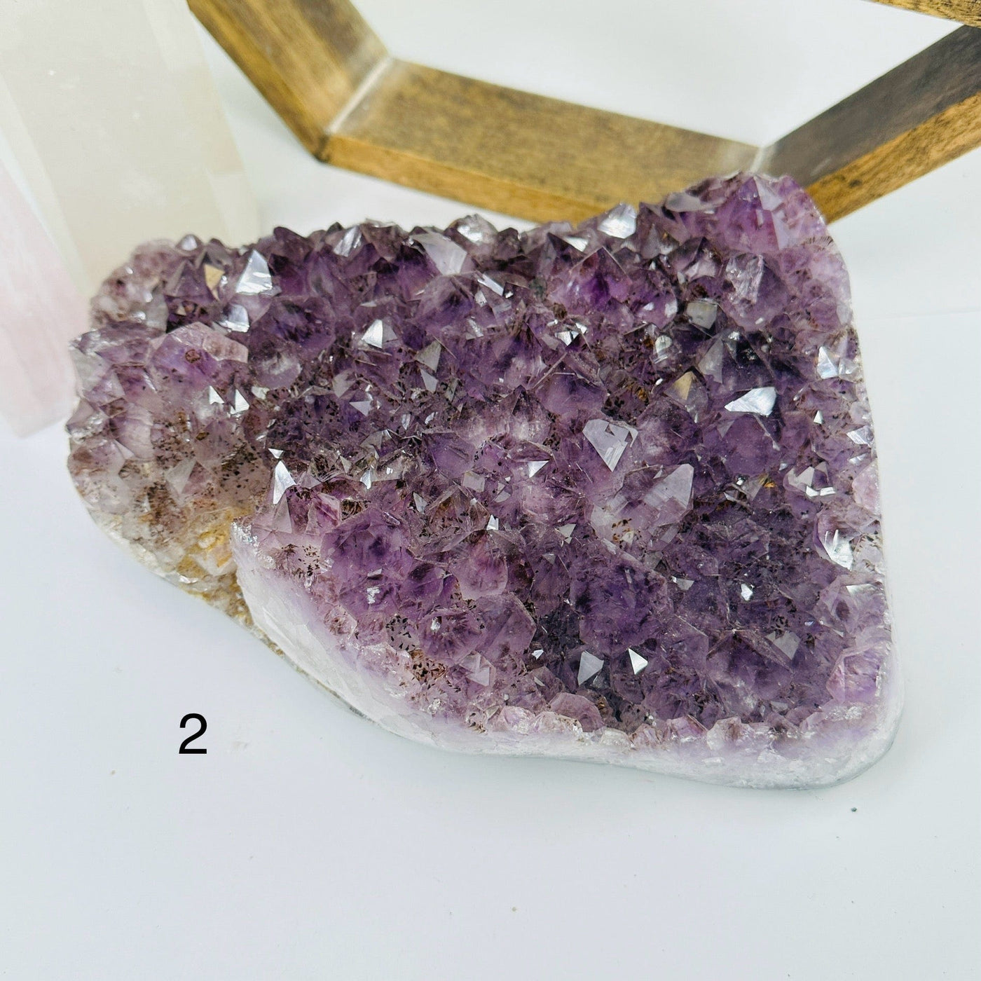 amethyst cluster with decorations in the background