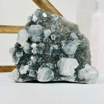 apophyllite cute base with decorations in the background