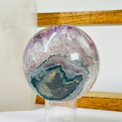 amethyst sphere with decorations in the background