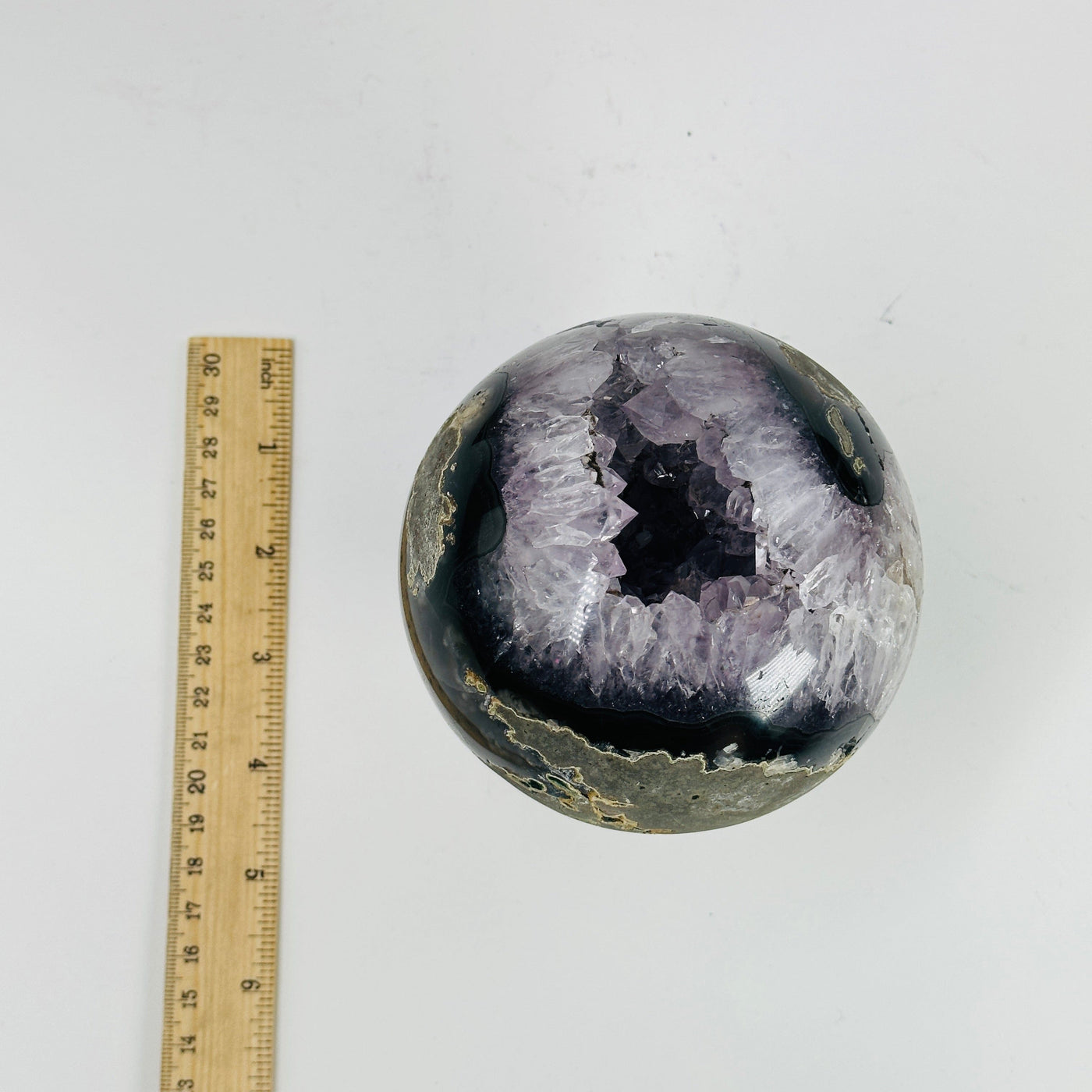amethyst sphere next to a ruler for size referece