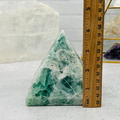Large Rainbow Fluorite Pyramid Crystal next to a ruler for size reference 