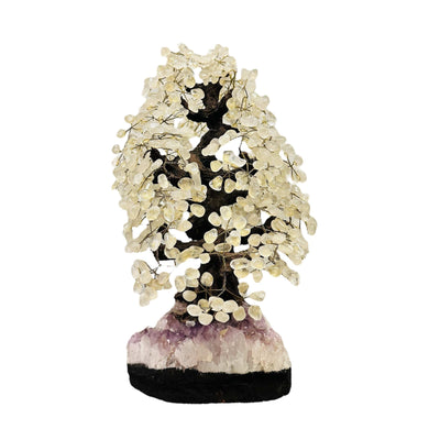 crystal quartz tree on amethyst stand on white background