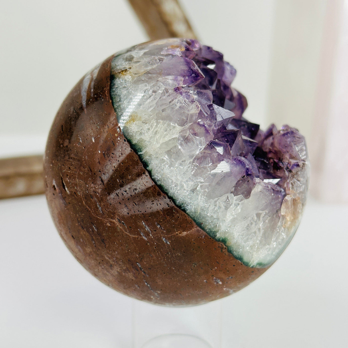 amethyst sphere with decorations in the background