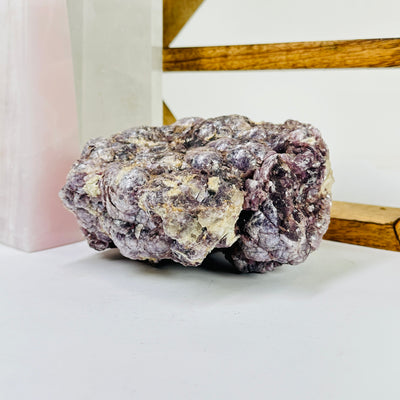 lepidolite with decorations in the background