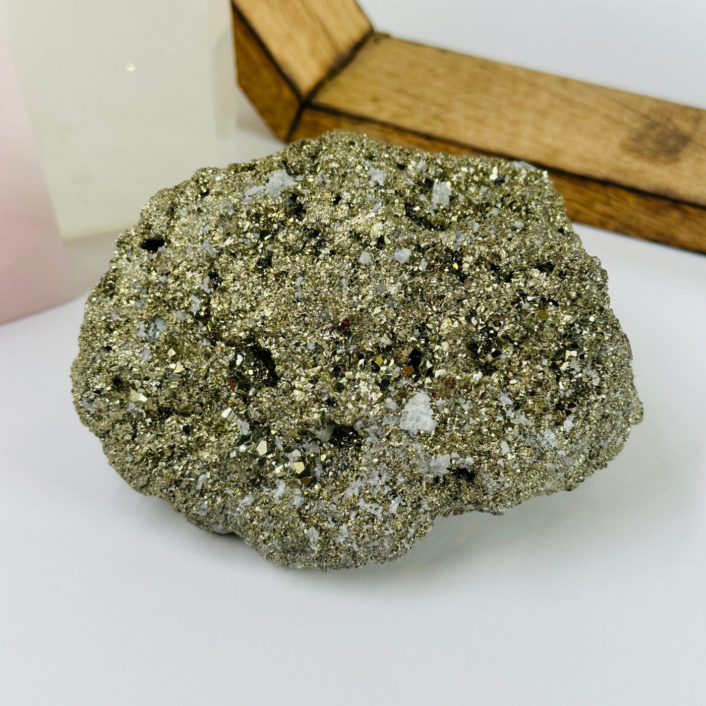 pyrite cluster with decorations  in the background