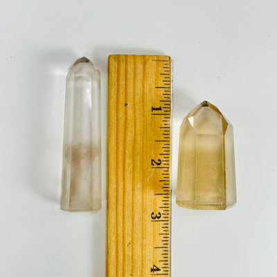 crystal quartz point next to a ruler for size reference