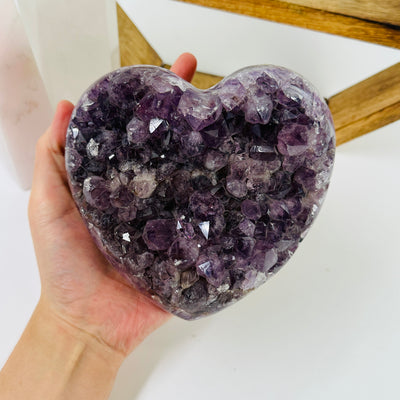 amethyst heart with decorations in the background