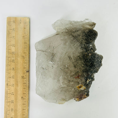 rutile quartz next to a ruler for size reference