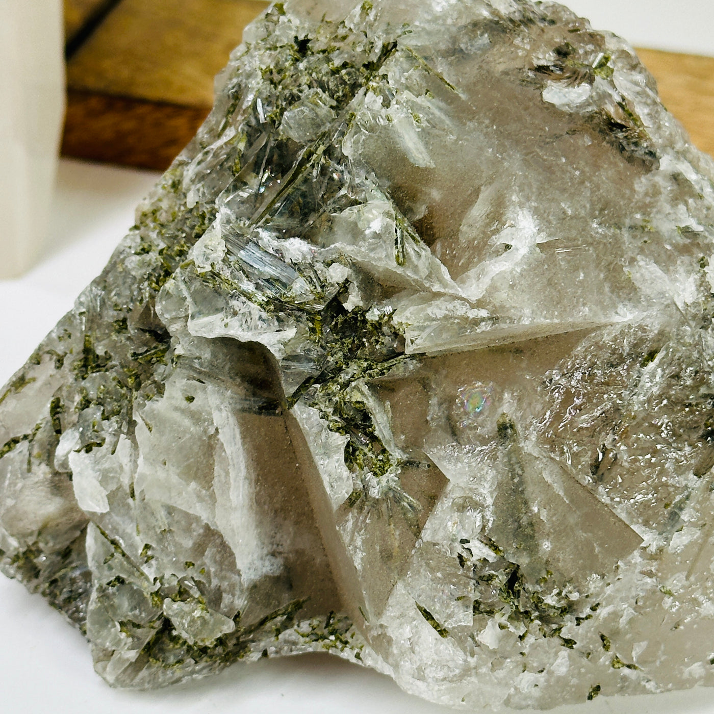 tourmaline on alligator quartz with decorations in the background