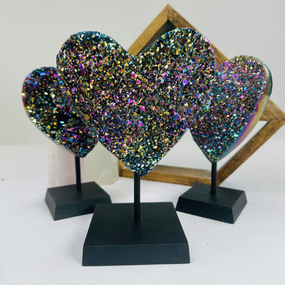 titanium coated heart on stand with decorations in the background