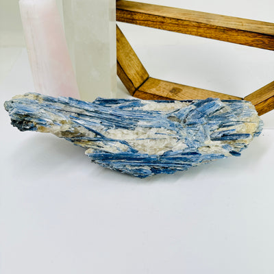 kyanite with decorations in the background