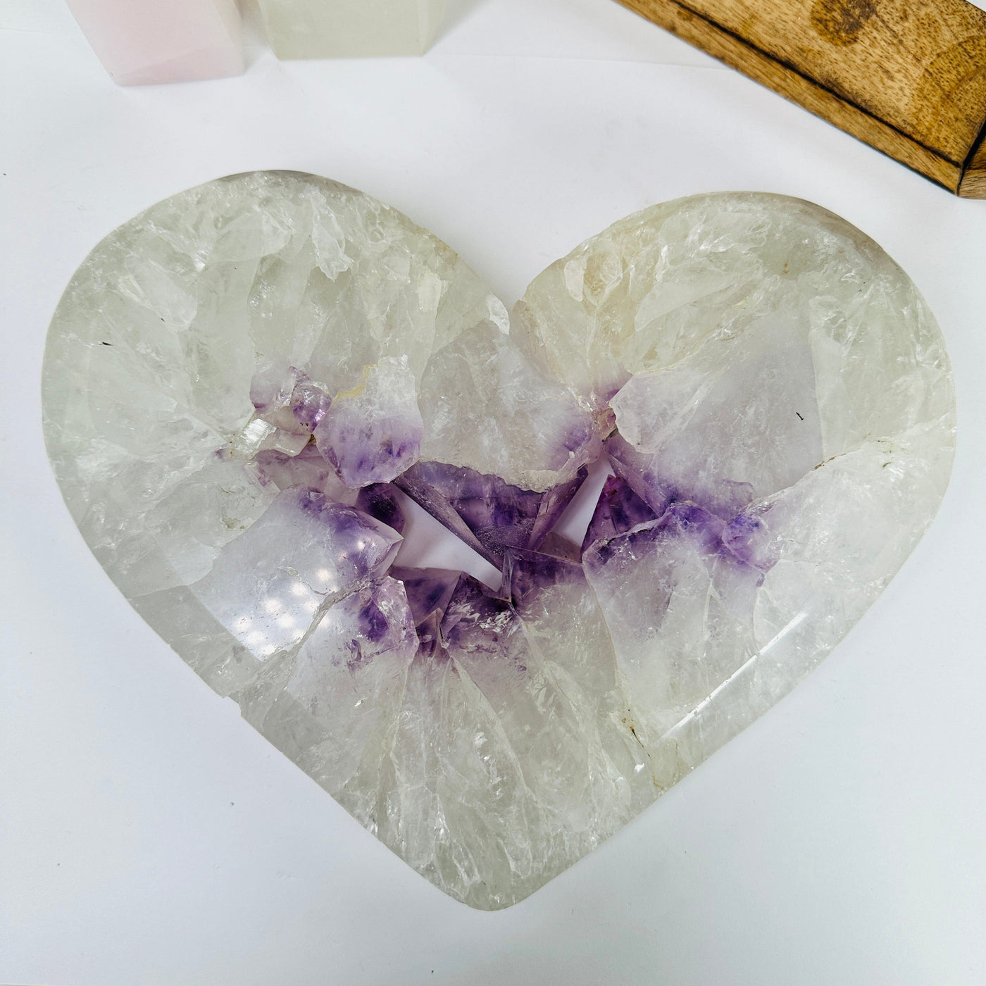 amethyst heart with decorations in the background