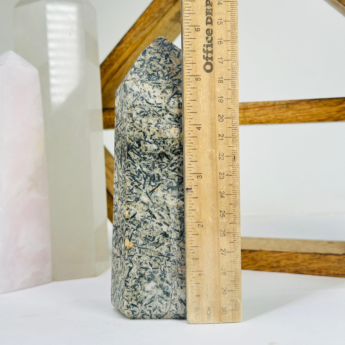 epidote point next to a ruler for size reference