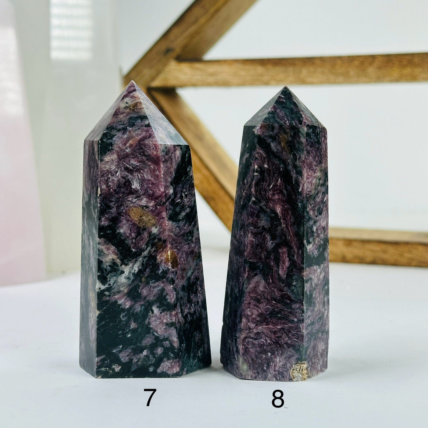 charoite points with decorations in the background