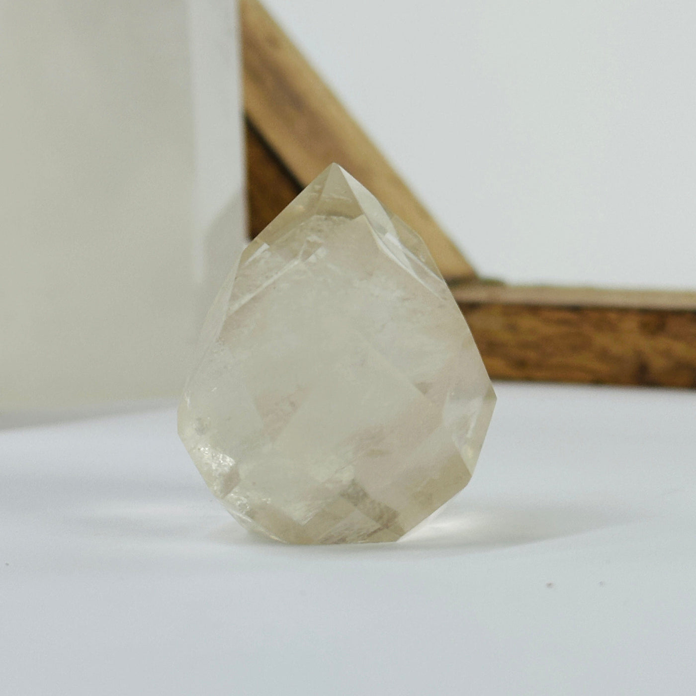 citrine faceted point with decorations in the background