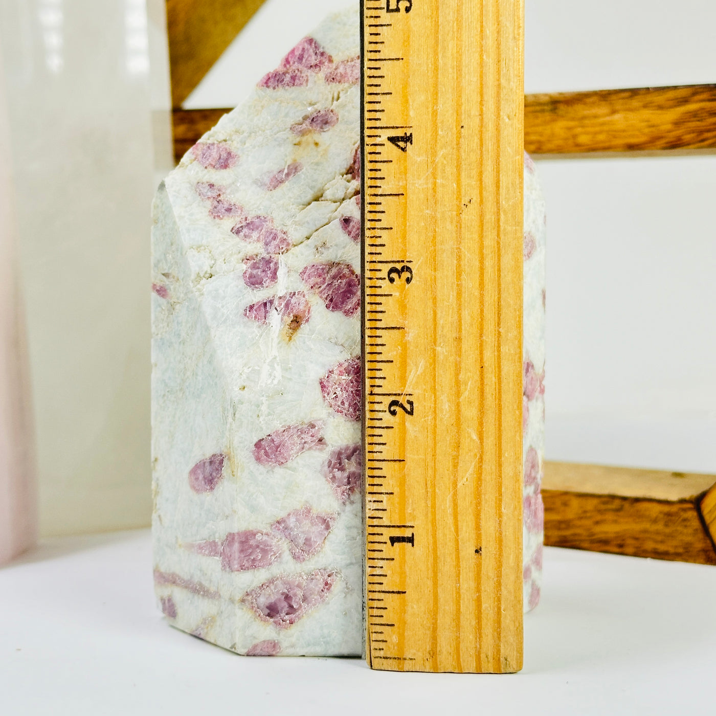 tourmaline point next to a ruler for size reference