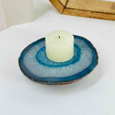teal agate coaster with decorations in the background