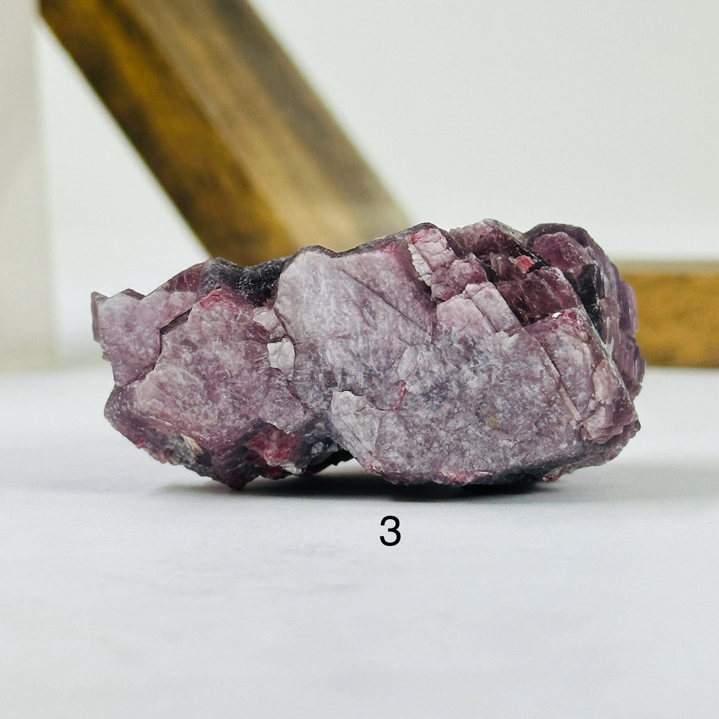 lepidolite cluster with decorations in the background