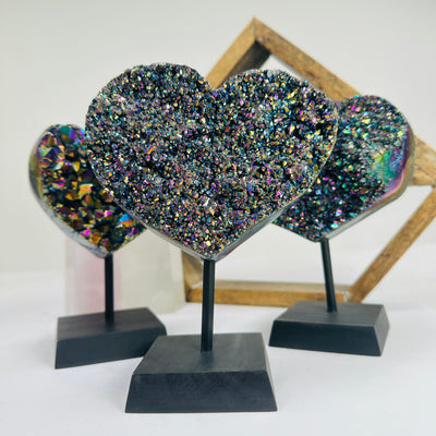 titanium coated heart on stand with decorations in the background