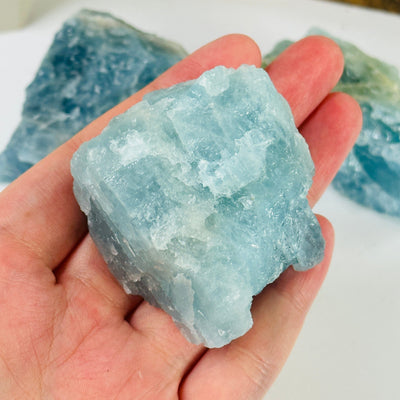 aquamarine stone with decorations in the background