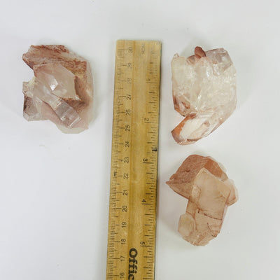 lithium quartz next to a ruler for size reference