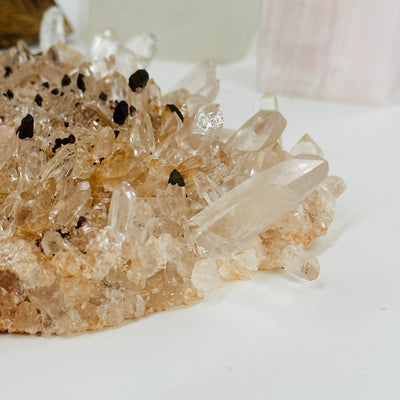 laser quartz cluster with decorations in the background