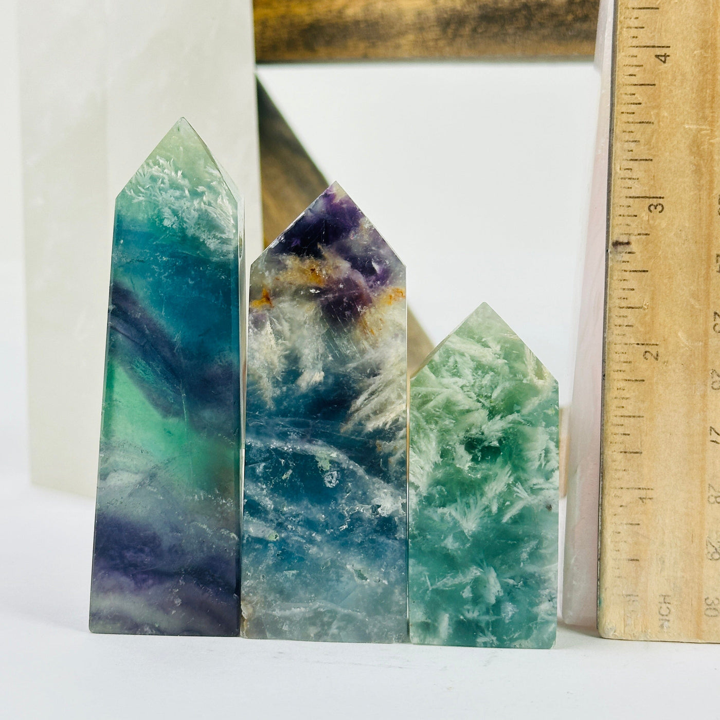 fluorite point with decorations in the background