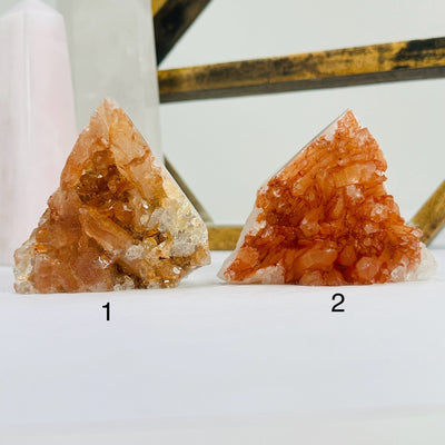 tangerine quartz points with decorations in the background