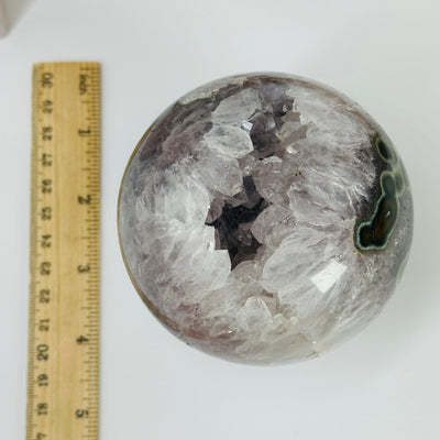 amethyst sphere  next to a ruler for size reference