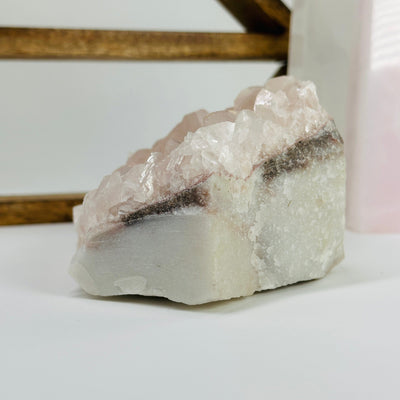 Pink chalcedony cluster with decorations in the background 