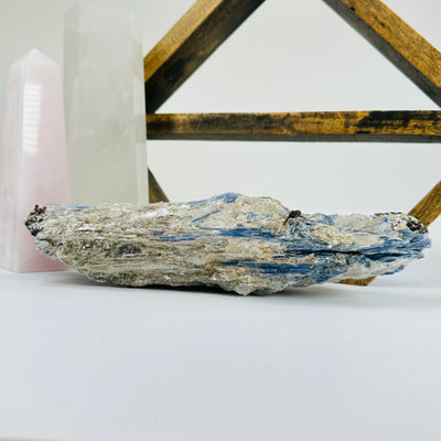 Kyanite with decorations in the background