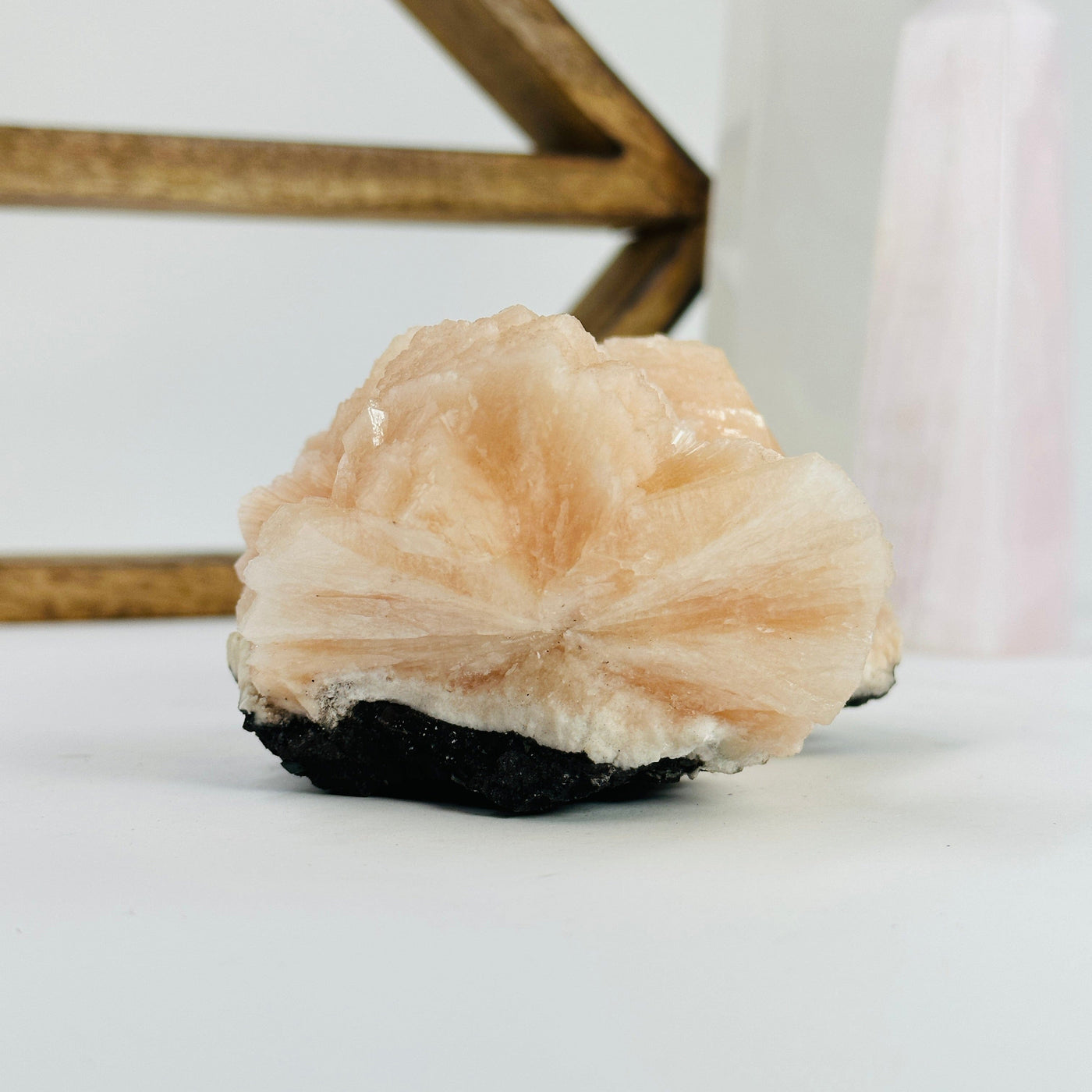 Peach stilbite with decorations in the background 