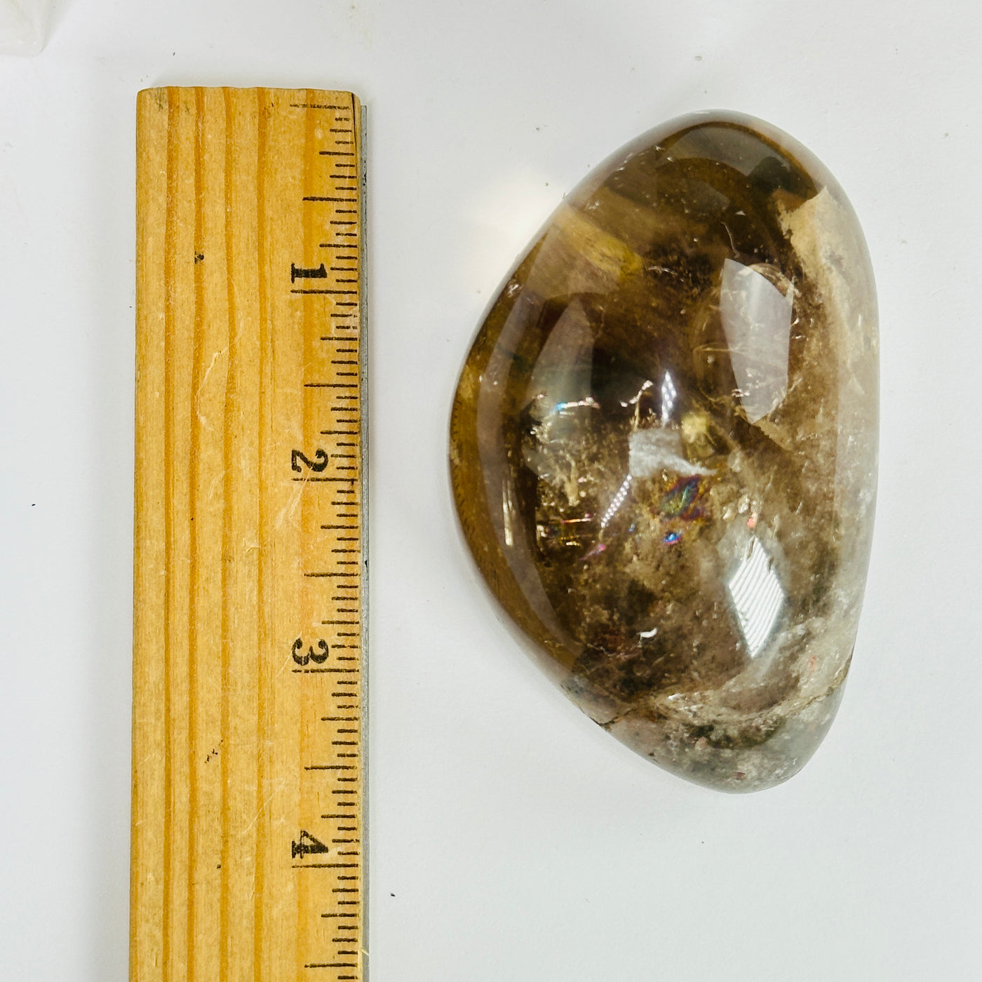 smokey quartz next to a ruler for size reference