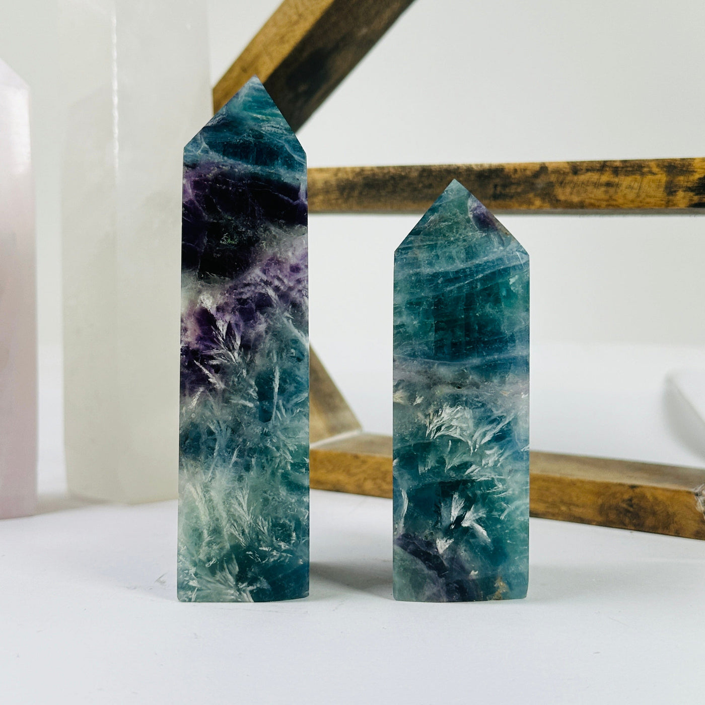 fluorite point with decorations in the background