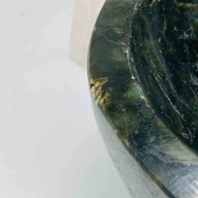 labradorite bowl with decorations in the background