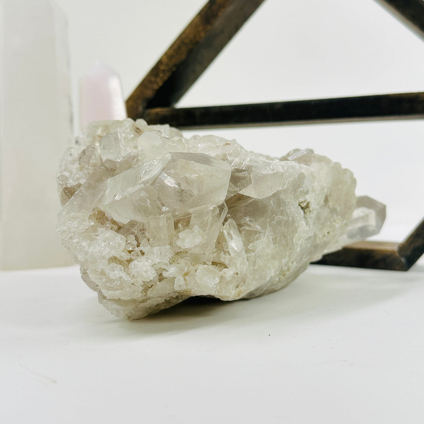 crystal quartz cluster with decorations in the background