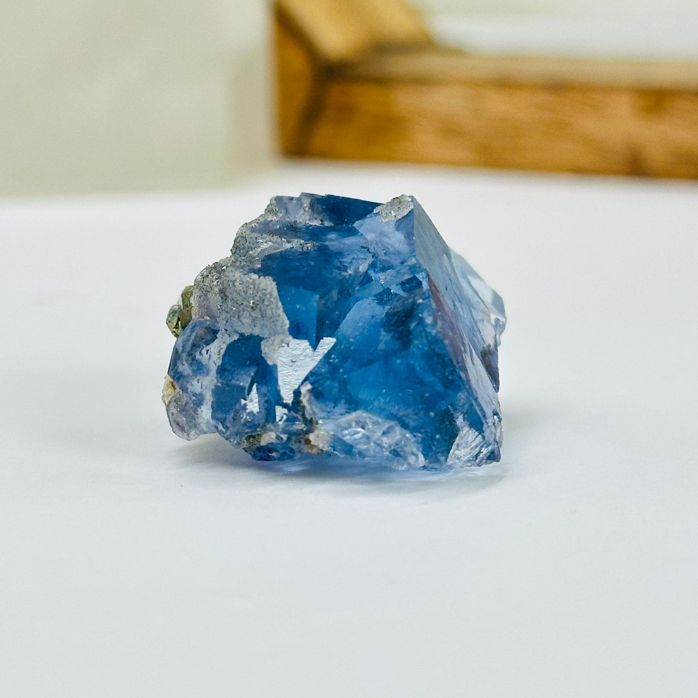 blue fluorite with decorations in the background