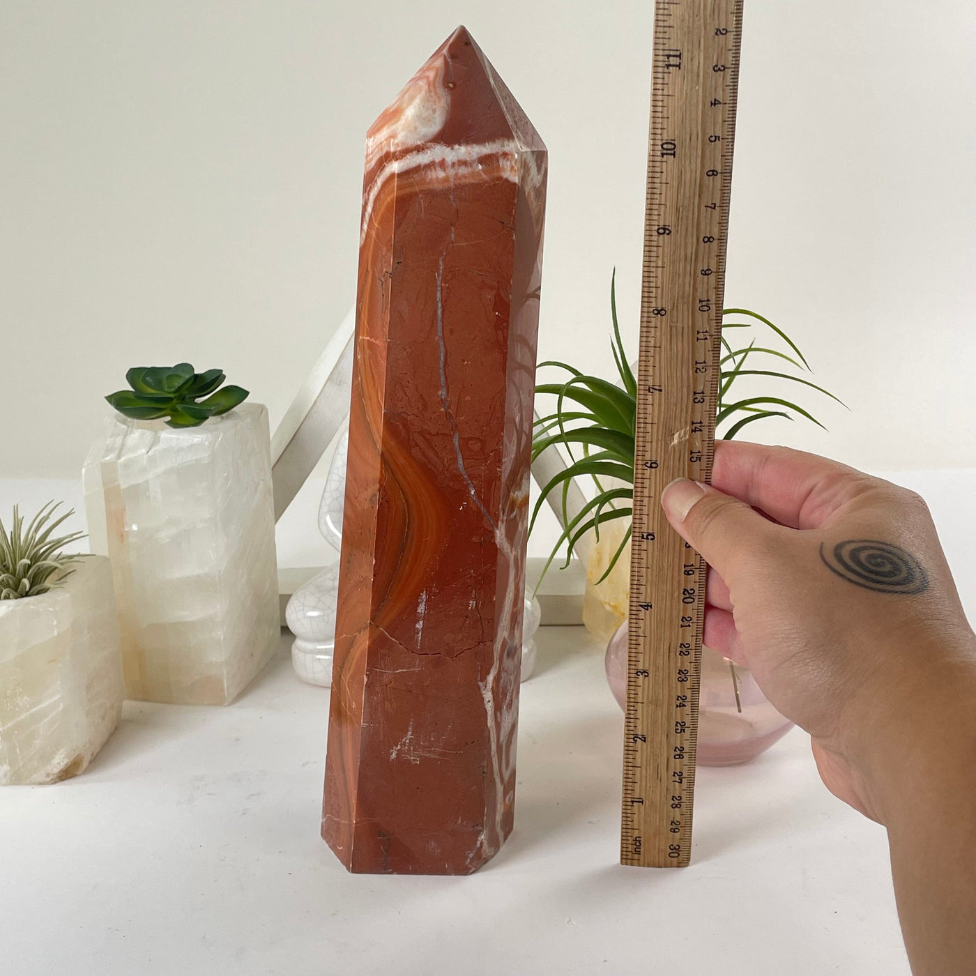 Red Jasper Crystal Obelisk with a ruler for size reference