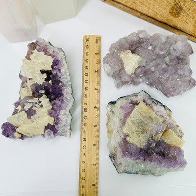 amethyst cluster next to a ruler for size reference