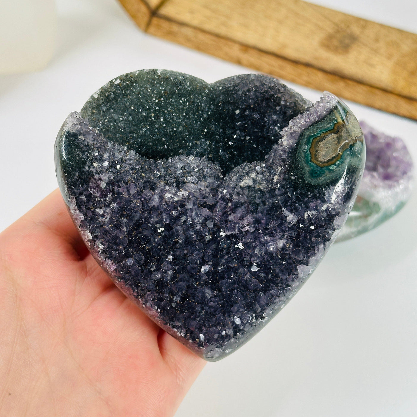 amethyst heart with decorations in the background