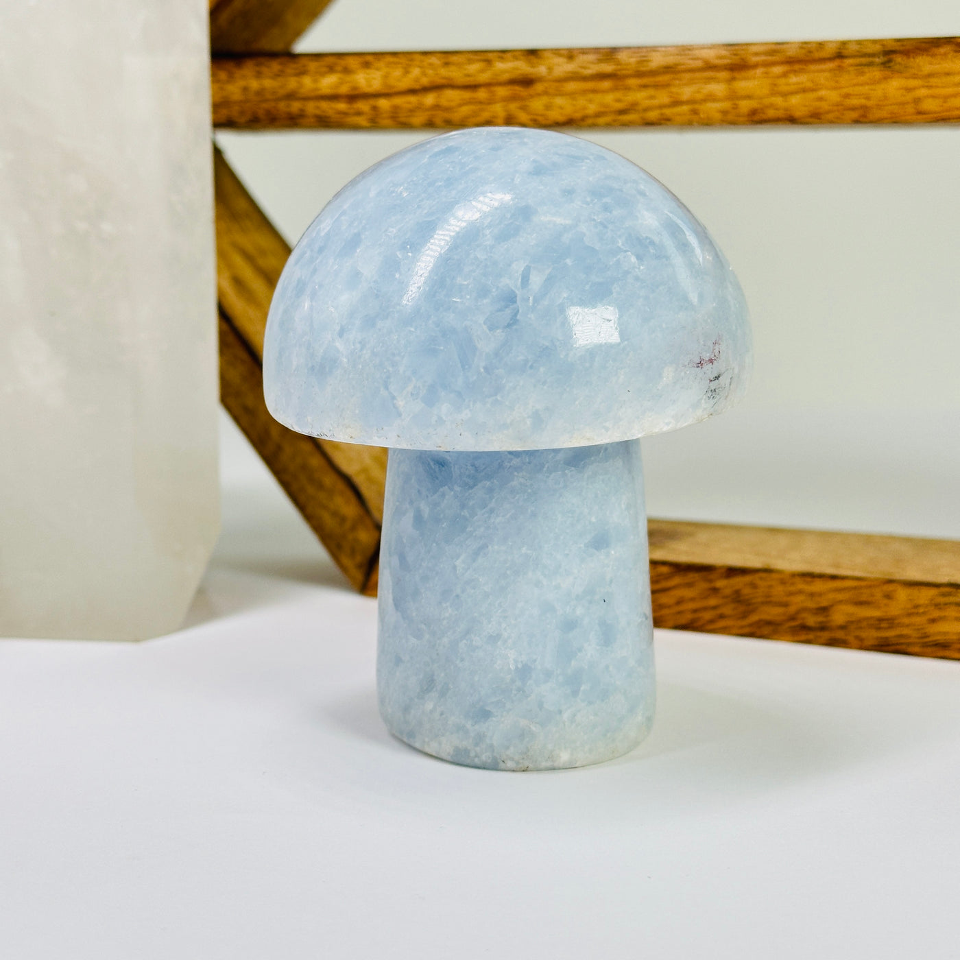 blue calcite mushroom with decorations in the background