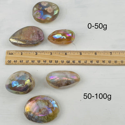  Flower Agate Palm Stones next to a ruler for size reference 