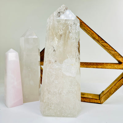 crystal quartz point with decorations in the background